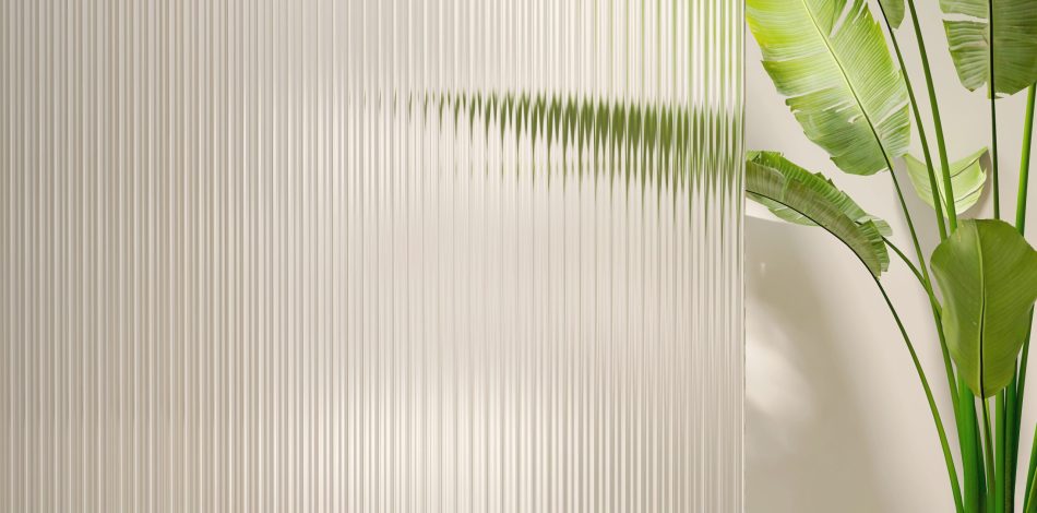 Healthy and beautiful tropical banana tree and glossy reeded glass partition in dappled sunlight on blank beige wall for luxury interior design, architecture and product display background